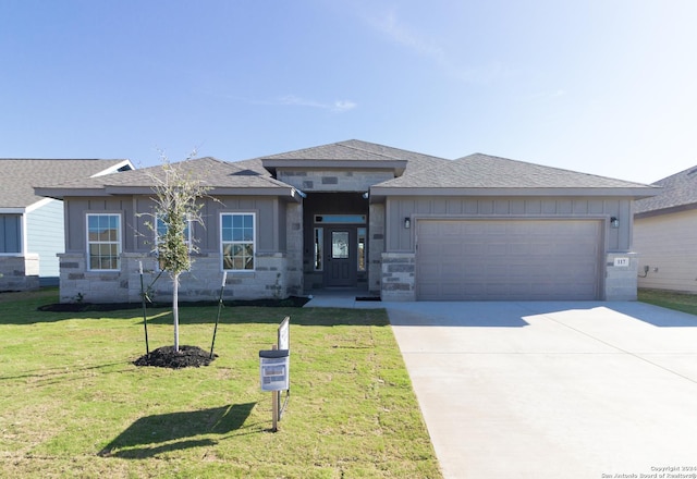 prairie-style home with a front lawn and a garage