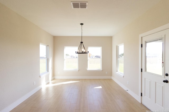 unfurnished dining area featuring light hardwood / wood-style flooring and plenty of natural light