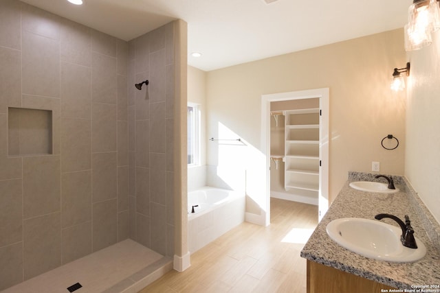 bathroom with vanity, hardwood / wood-style floors, and separate shower and tub