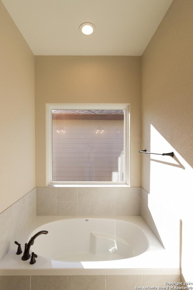 bathroom featuring tiled bath