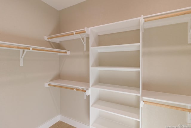 walk in closet with hardwood / wood-style floors