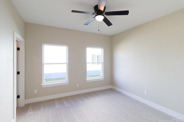 carpeted spare room with ceiling fan