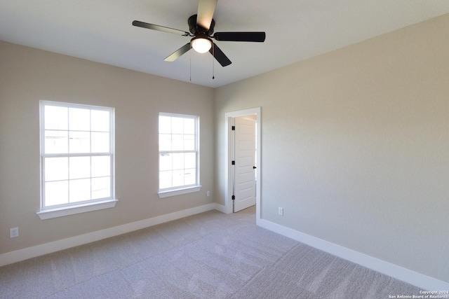 empty room featuring light carpet and ceiling fan