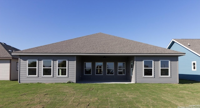 rear view of property with a lawn and a patio area