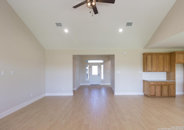 unfurnished living room with lofted ceiling, light hardwood / wood-style floors, and ceiling fan