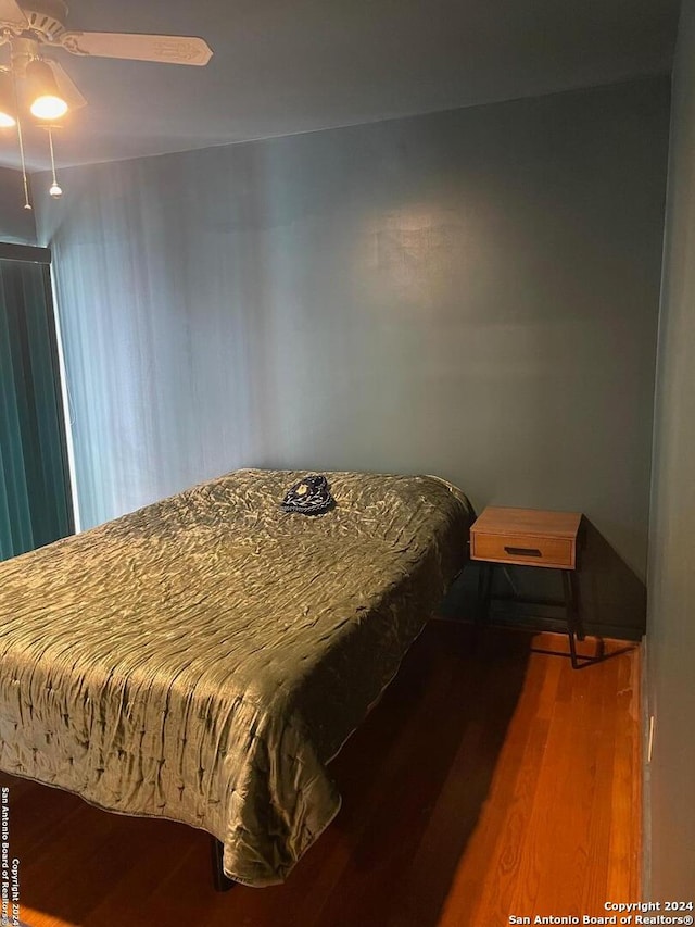 bedroom featuring ceiling fan and hardwood / wood-style flooring