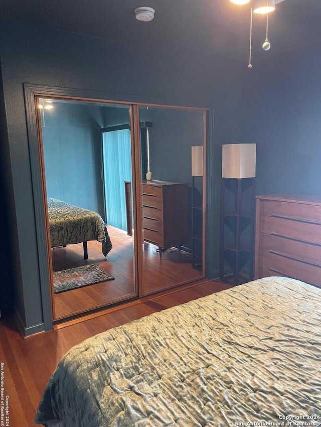 bedroom with dark hardwood / wood-style flooring