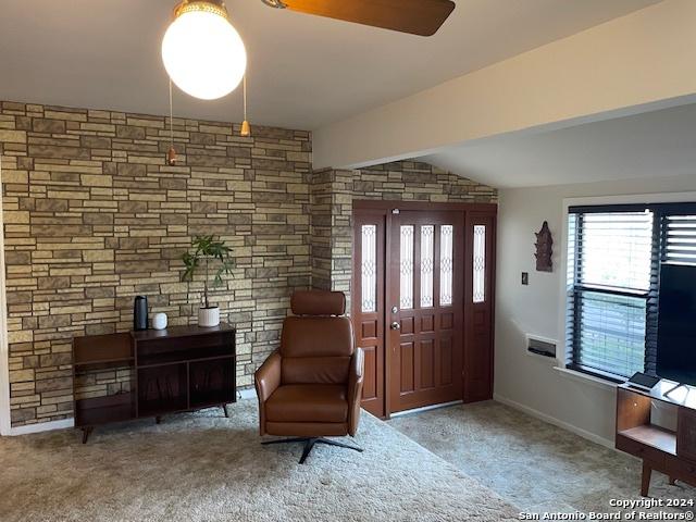 foyer entrance with light colored carpet and plenty of natural light