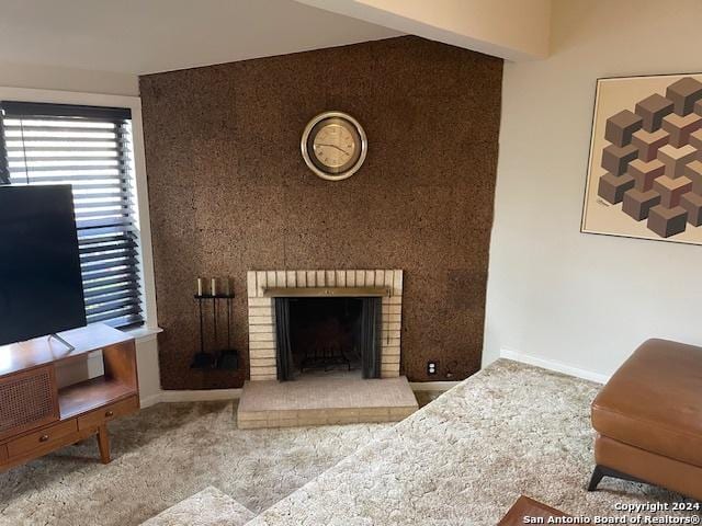 carpeted living room featuring a brick fireplace