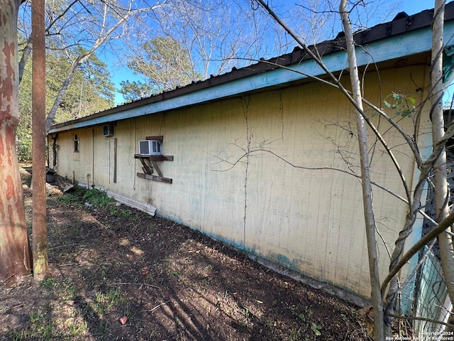 view of home's exterior featuring an AC wall unit