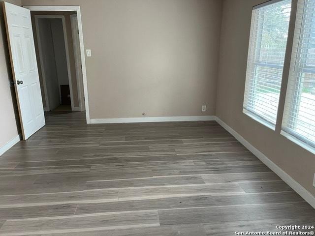 empty room with hardwood / wood-style floors