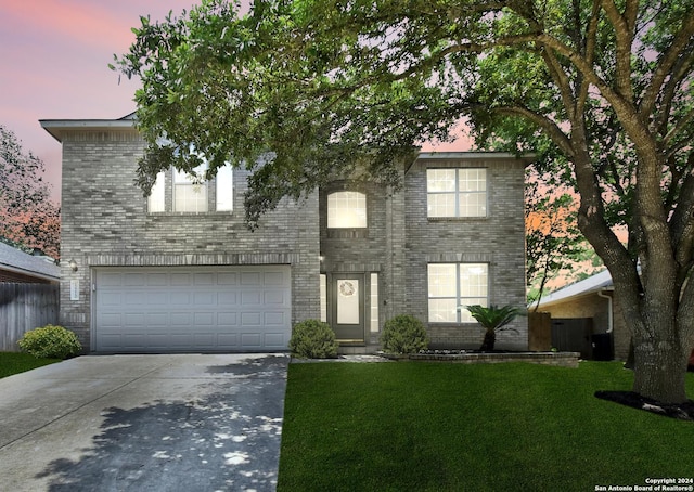 view of front facade with a yard and a garage