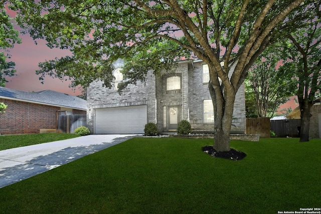 view of front of house featuring a lawn and a garage