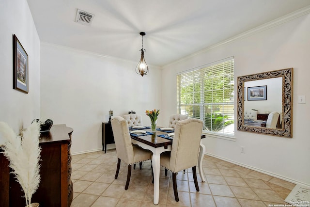 dining space featuring light tile patterned floors and ornamental molding