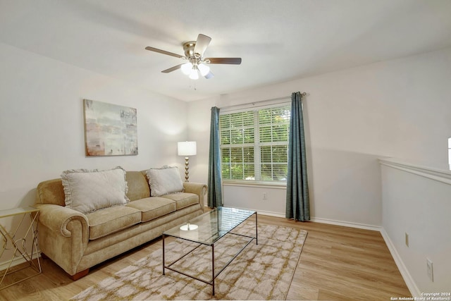 living room featuring ceiling fan and light hardwood / wood-style flooring