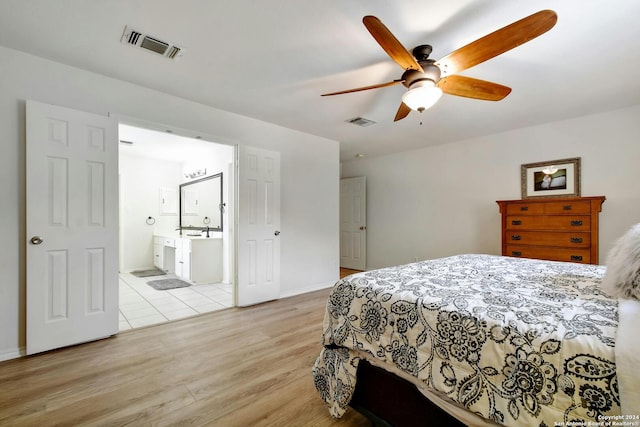 bedroom featuring ensuite bathroom, ceiling fan, and light hardwood / wood-style floors