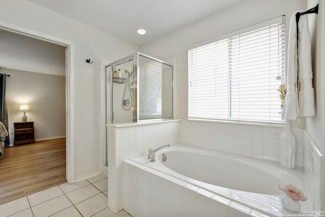 bathroom with tile patterned flooring and independent shower and bath