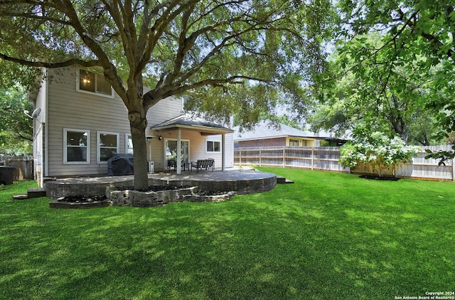 rear view of house with a yard and a patio area