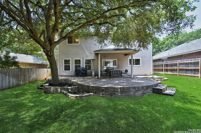 back of property featuring a lawn and a patio area