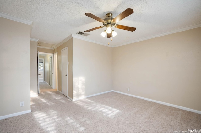 carpeted empty room with ceiling fan, ornamental molding, and a textured ceiling