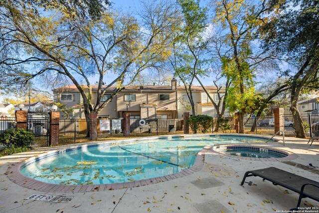 view of pool featuring a community hot tub