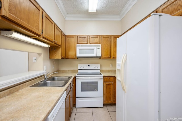 kitchen featuring sink, a textured ceiling, light tile patterned floors, ornamental molding, and white appliances