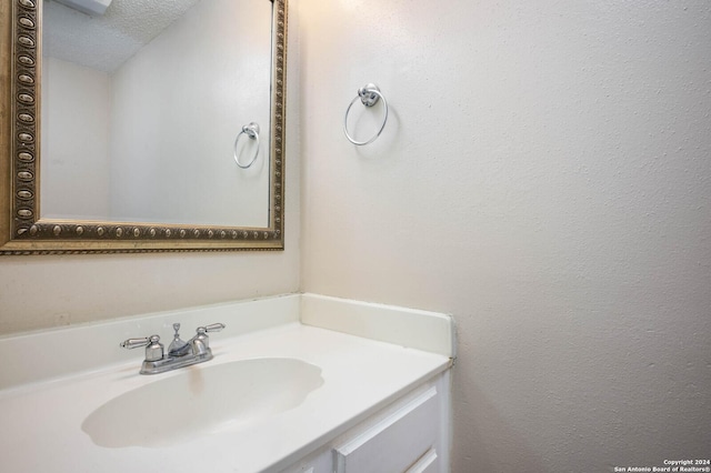 bathroom with vanity and a textured ceiling