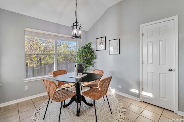 dining room featuring light tile patterned flooring, a chandelier, and vaulted ceiling