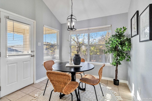 tiled dining area with an inviting chandelier and vaulted ceiling