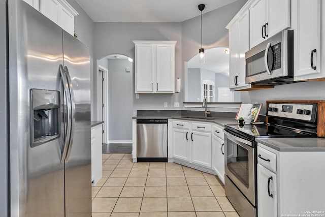 kitchen with pendant lighting, stainless steel appliances, white cabinetry, and sink