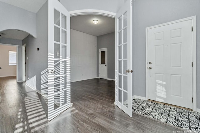 foyer entrance featuring french doors and dark hardwood / wood-style floors