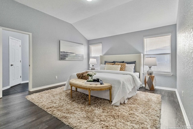 bedroom featuring dark hardwood / wood-style flooring and vaulted ceiling