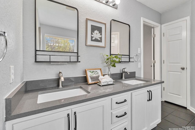 bathroom featuring tile patterned flooring and vanity