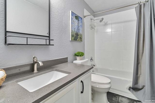 full bathroom with shower / bath combination with curtain, vanity, a textured ceiling, and toilet