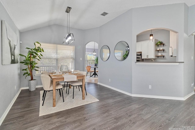 dining room with dark hardwood / wood-style floors and vaulted ceiling