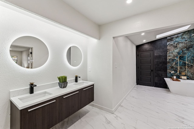 bathroom featuring a washtub and vanity