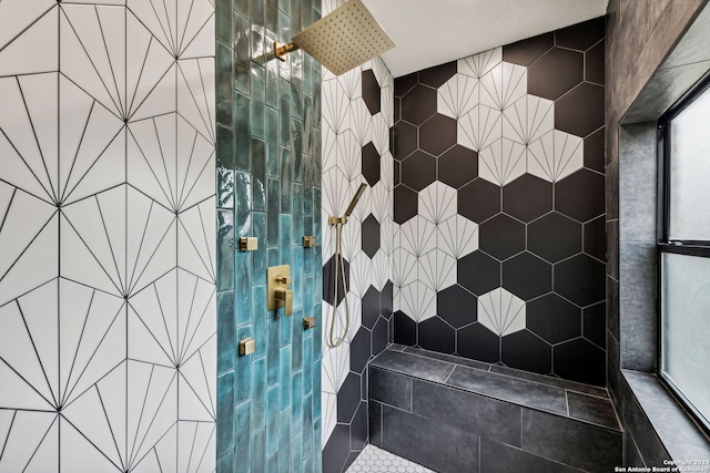 bathroom with a tile shower