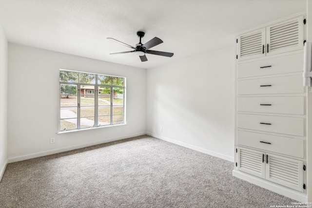 empty room with ceiling fan and carpet floors