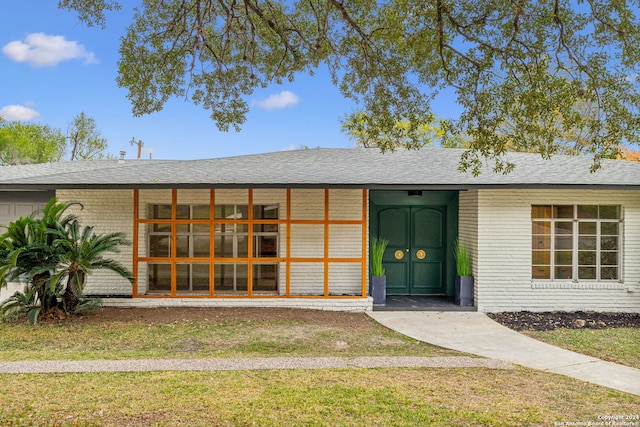 entrance to property featuring a yard