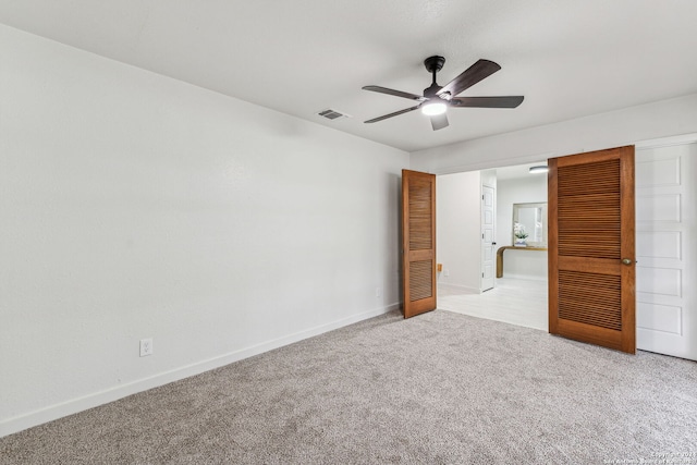 unfurnished bedroom with light carpet and ceiling fan