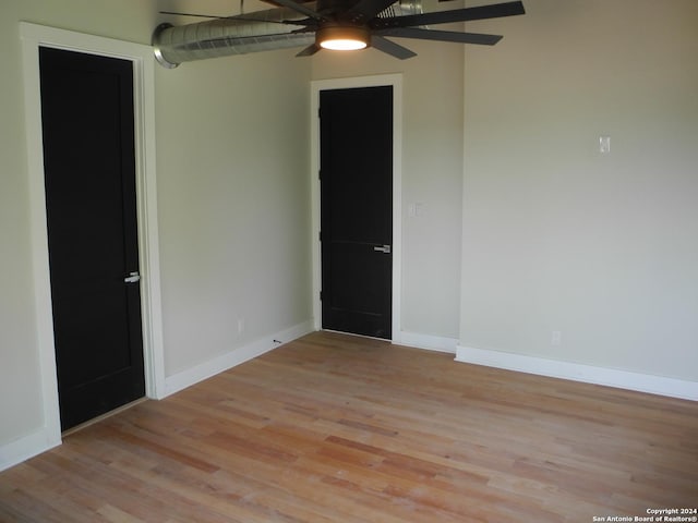 spare room featuring ceiling fan and light hardwood / wood-style floors