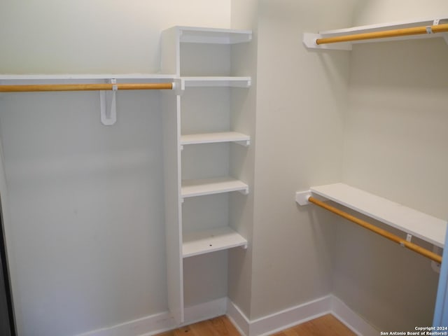 spacious closet featuring light hardwood / wood-style flooring