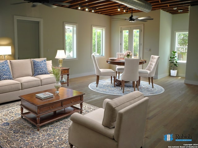 living room featuring a wealth of natural light, hardwood / wood-style floors, and ceiling fan