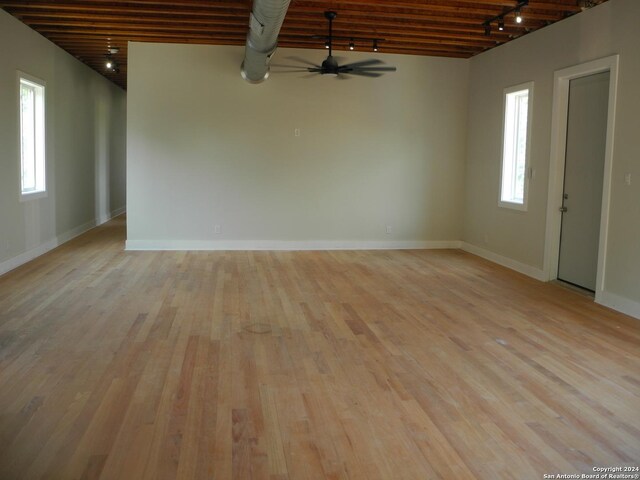 unfurnished room with a wealth of natural light, ceiling fan, and light wood-type flooring