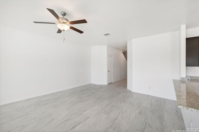 unfurnished living room featuring ceiling fan