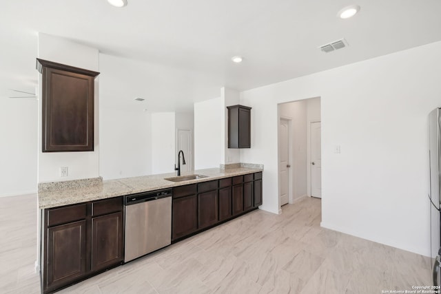 kitchen with stainless steel dishwasher, kitchen peninsula, dark brown cabinetry, and sink