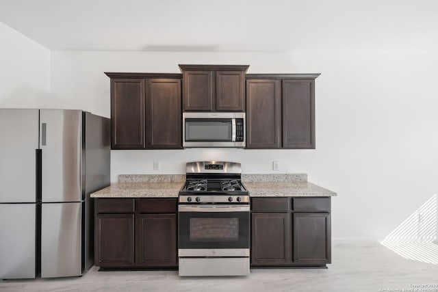 kitchen featuring appliances with stainless steel finishes and dark brown cabinets