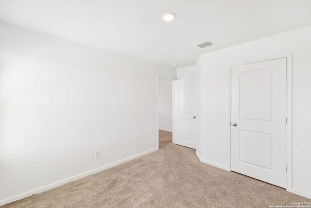 unfurnished bedroom with light colored carpet