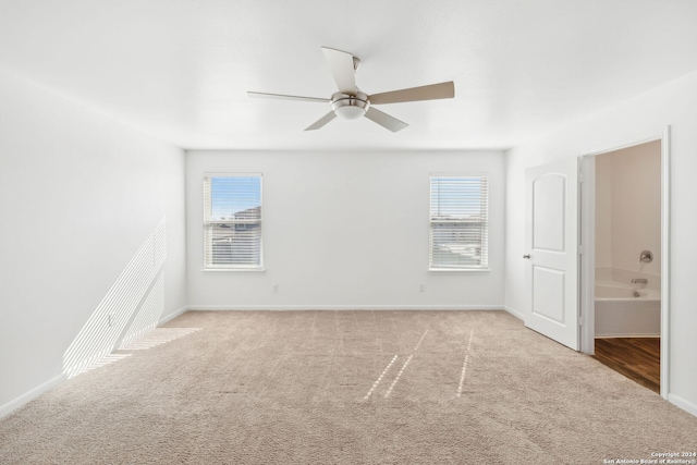 carpeted spare room featuring ceiling fan