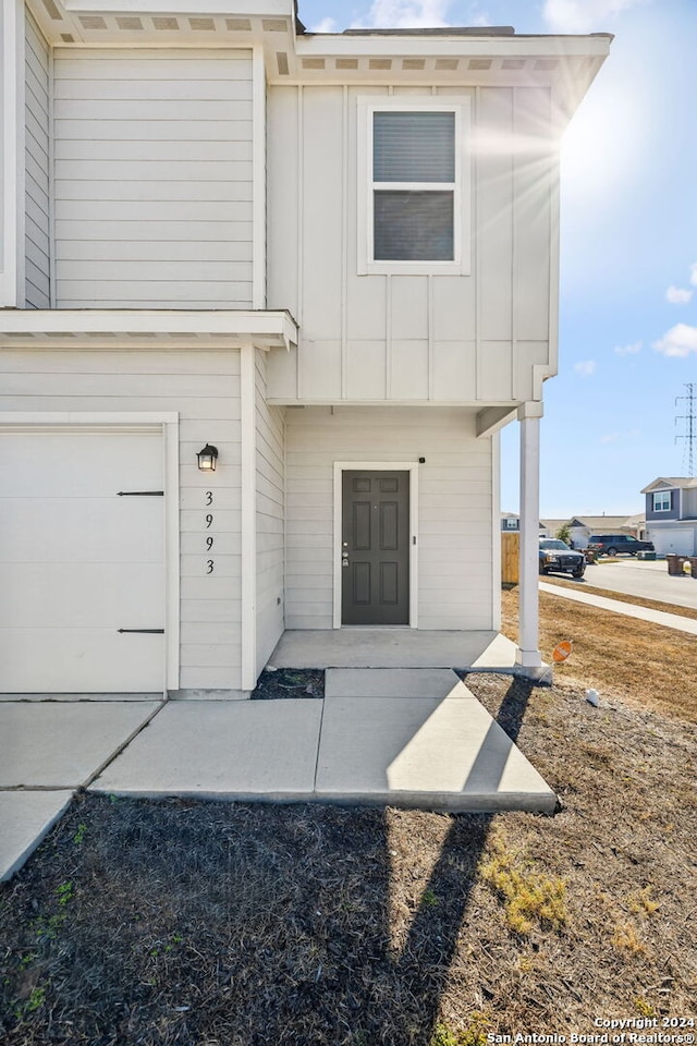 view of exterior entry with a garage